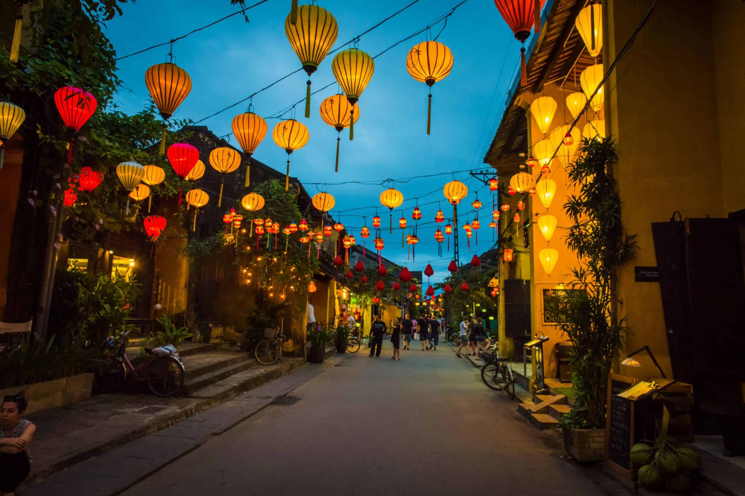 Colorful lanterns illuminating the streets of Hoi An Ancient Town at sunset