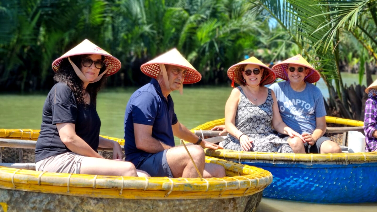 Families and senior travelers enjoying the Cam Thanh Coconut Village Palm Forest experience