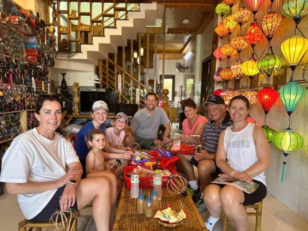 Families and travelers enjoying a creative workshop in Hoi An