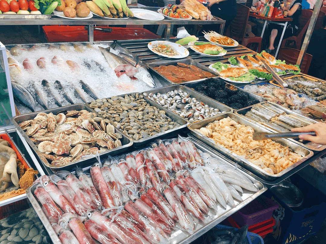 Fresh seafood and grilled street snacks at a local food stall in Hue