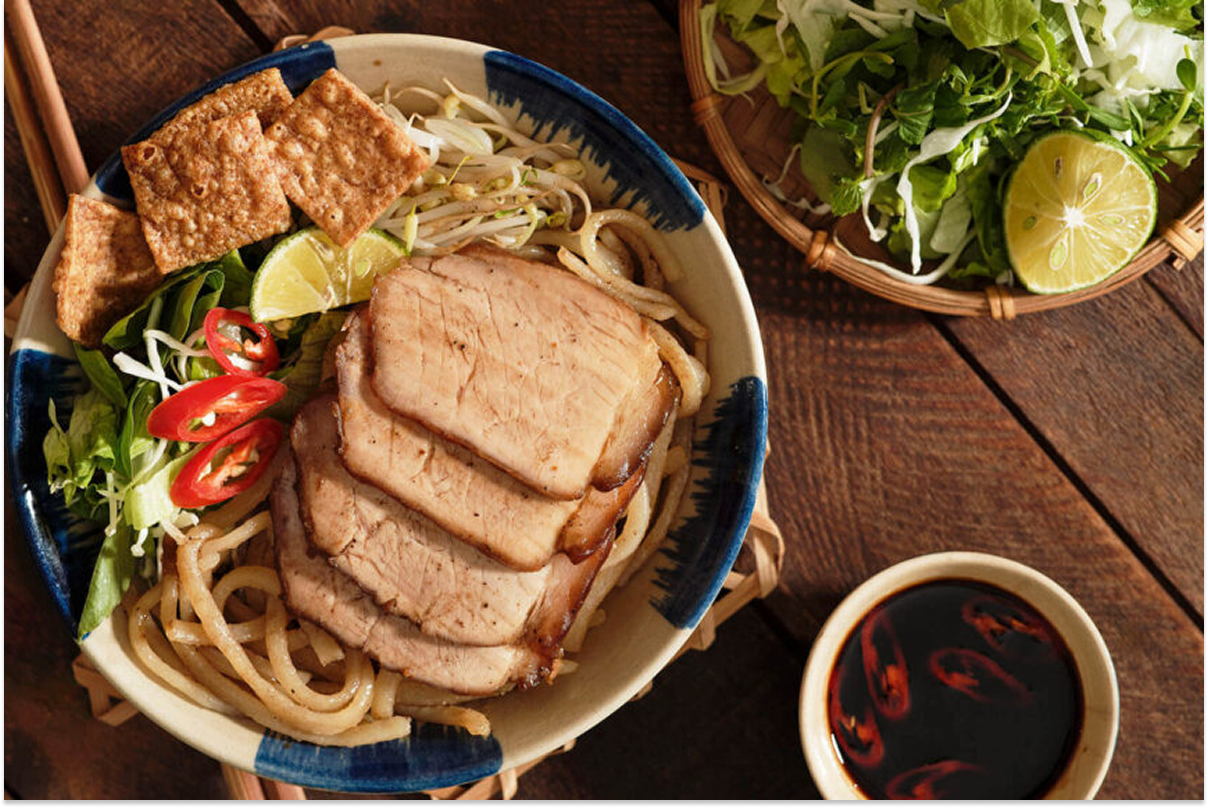 Traditional Hoi An dishes including cao lau and grilled seafood