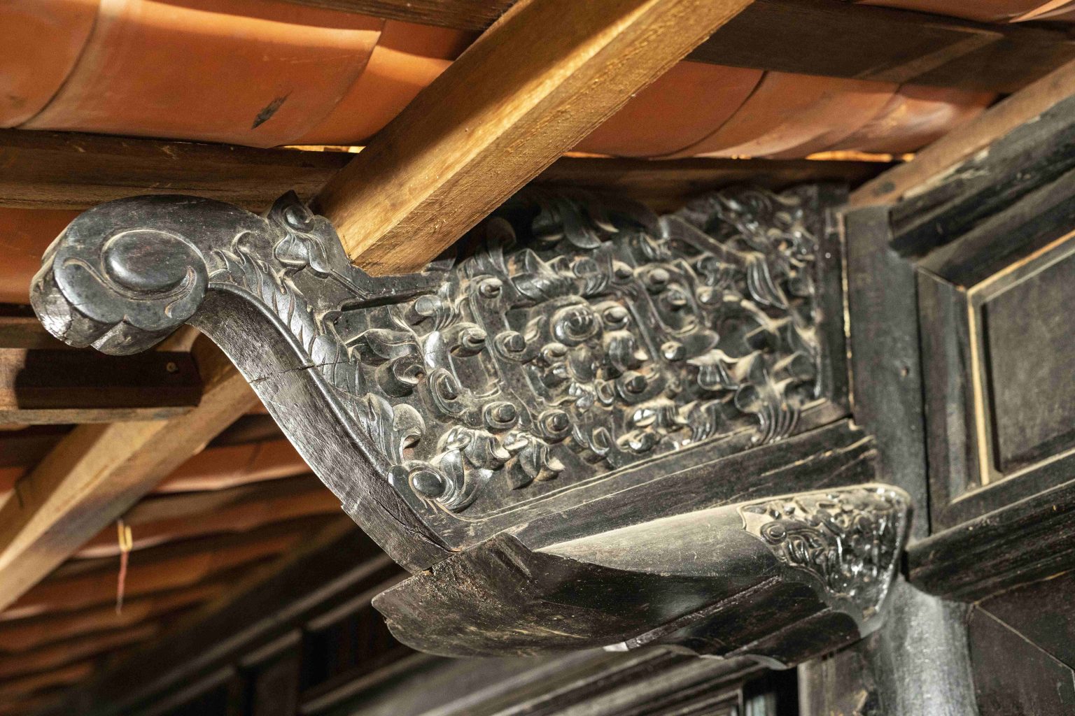Intricate wooden carvings inside a historic building in Hoi An