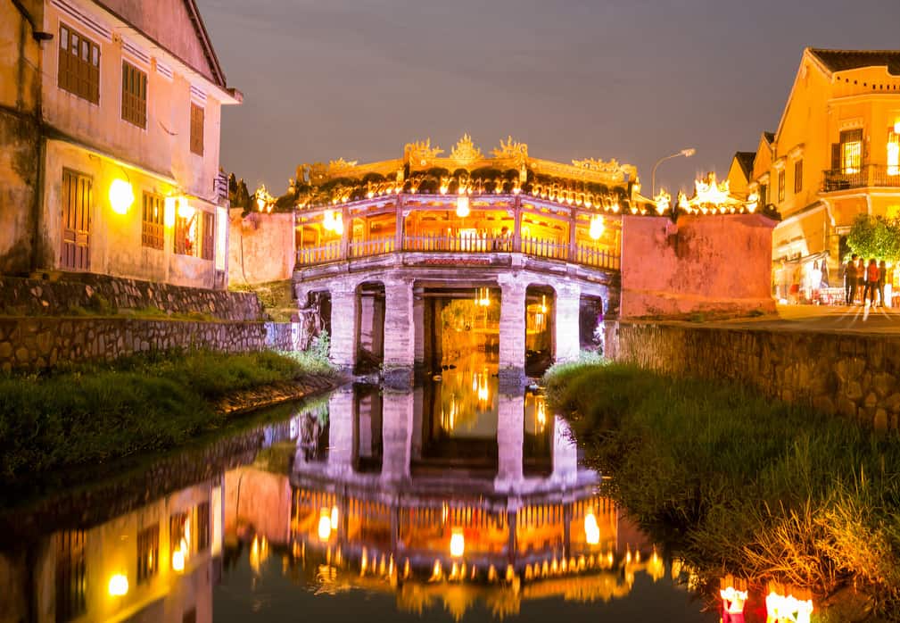 Lantern-lit evening view of the historic bridge in Hoi An