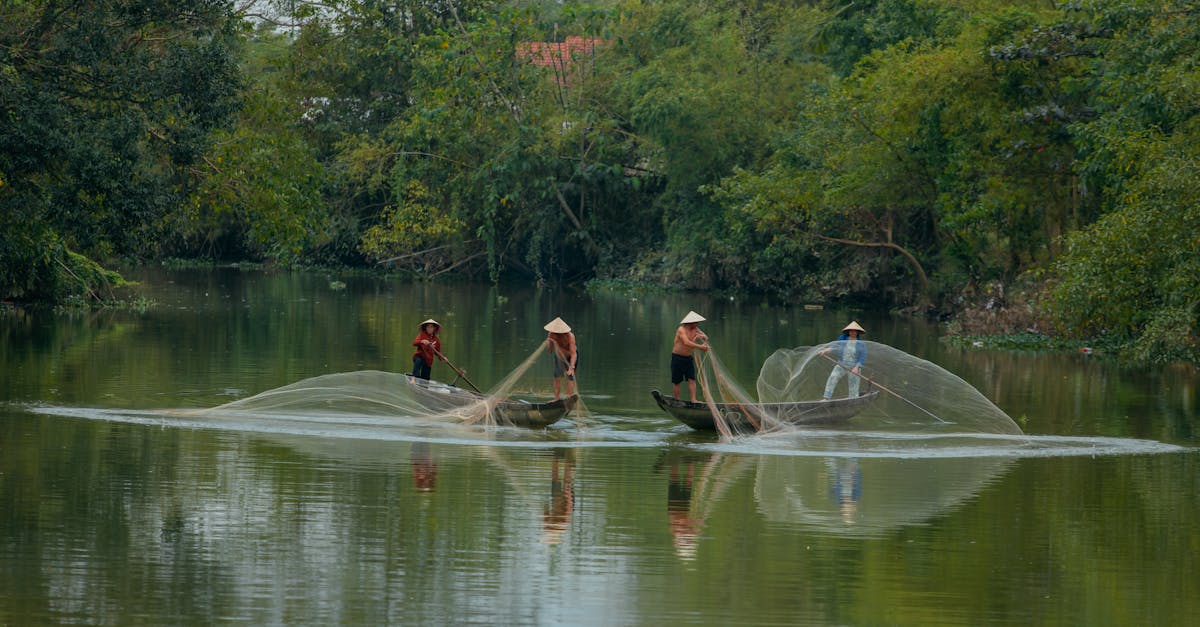 Local fishermen casting nets in a traditional riverside setting