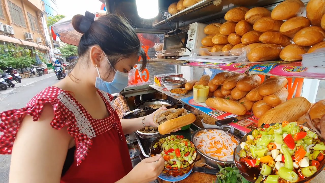 Morning banh mi vendor in Hanoi Old Quarter serving local breakfast