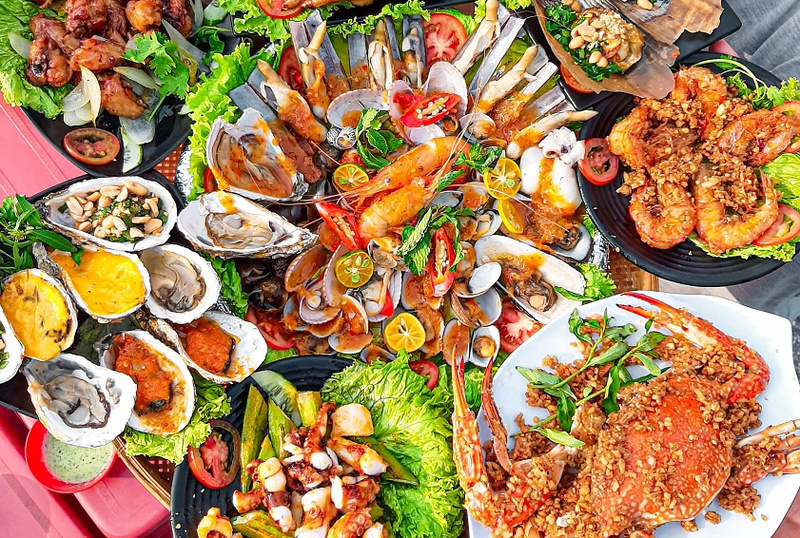 Outdoor seaside dining with ocean views at sunset