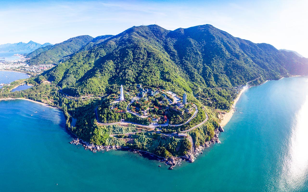 Panoramic view of forested hills overlooking the coastal city skyline.