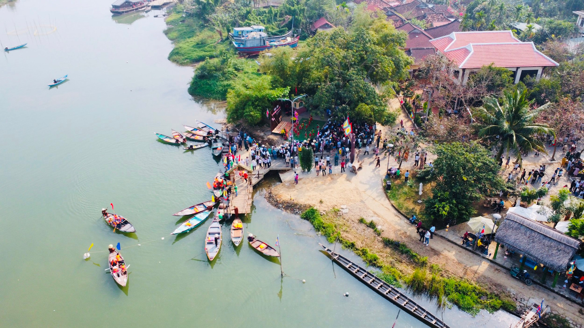Riverside view of a traditional woodworking village near Hoi An with boats on Thu Bon River