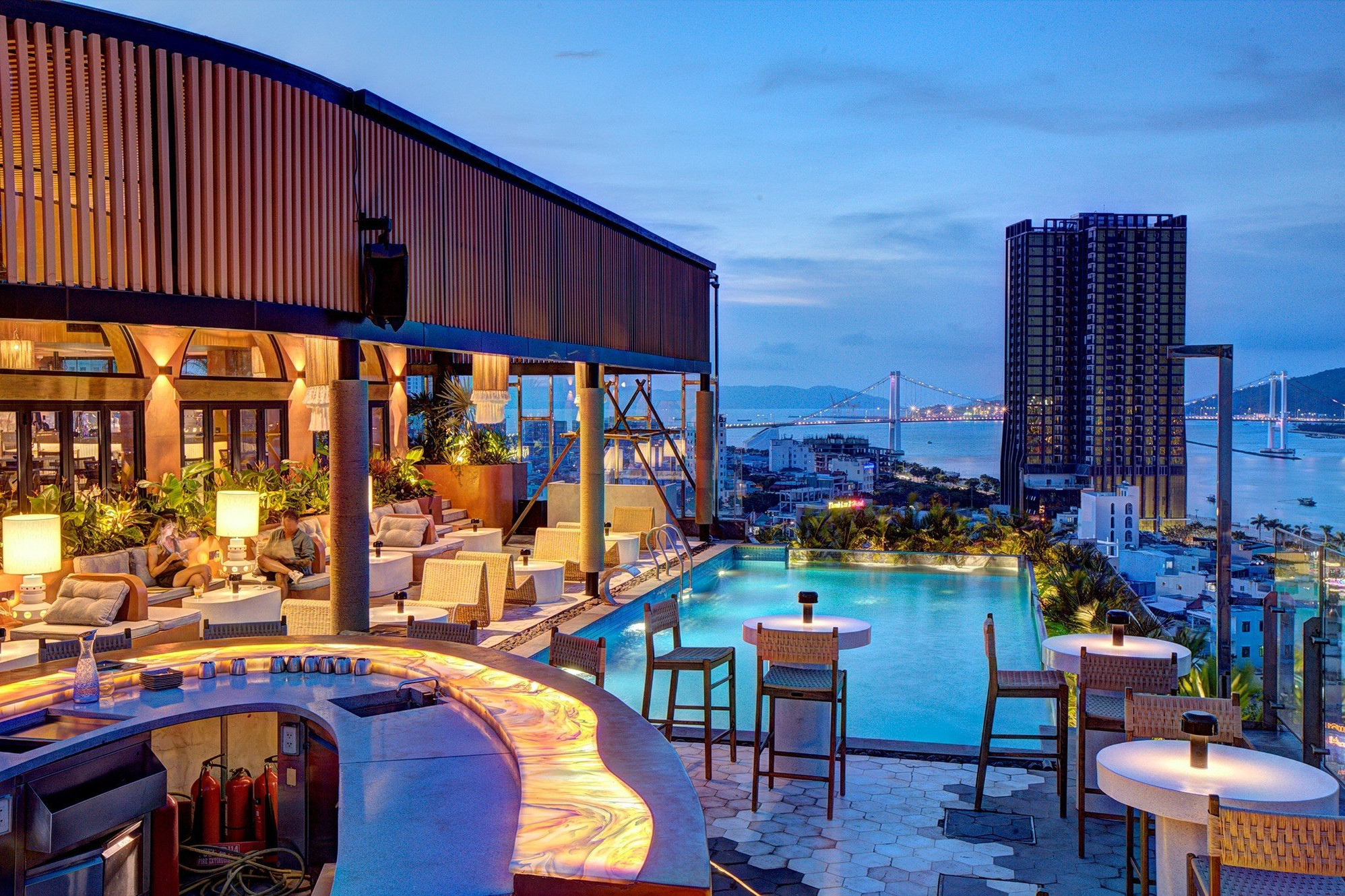 Rooftop cocktail bar overlooking the illuminated city skyline