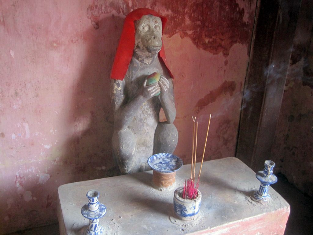 Stone guardian statue at the entrance of the historic bridge in Hoi An