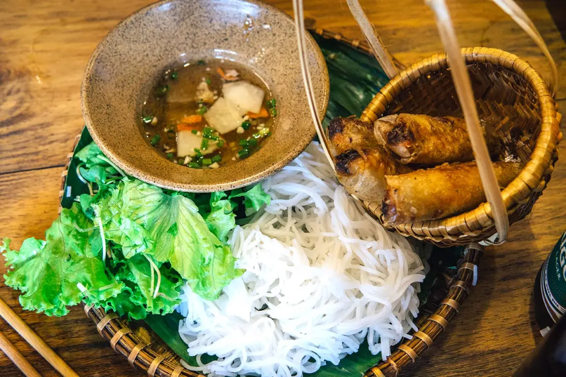 Traditional Vietnamese dishes served at a riverside restaurant near Hoi An