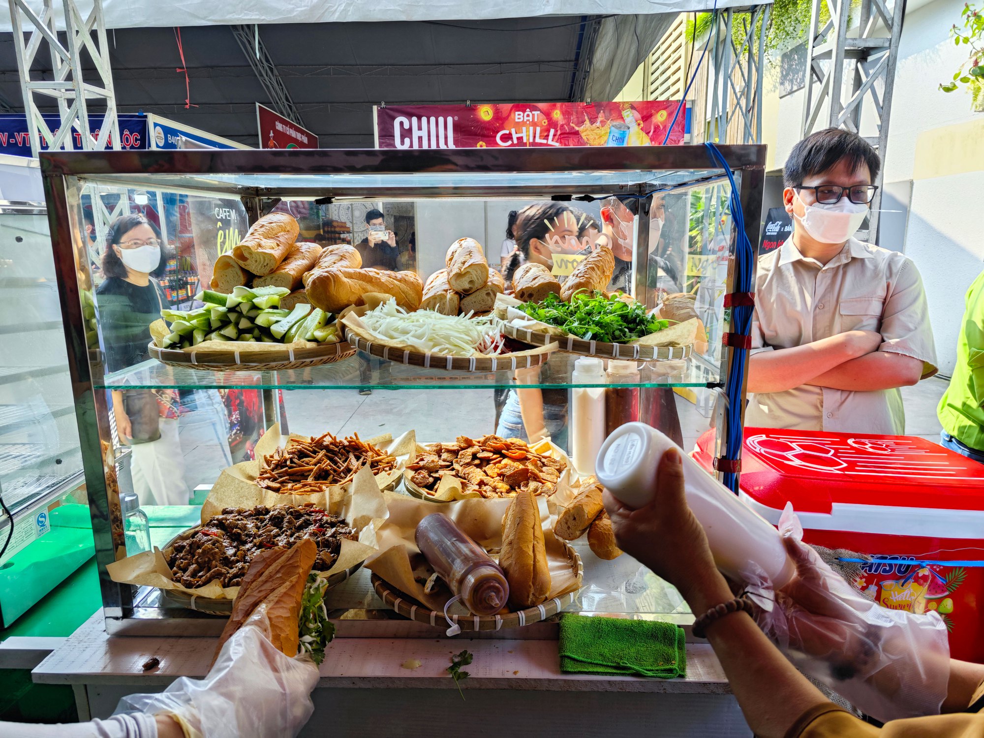 Traditional banh mi street stall in Vietnam with fresh baguettes and local customers