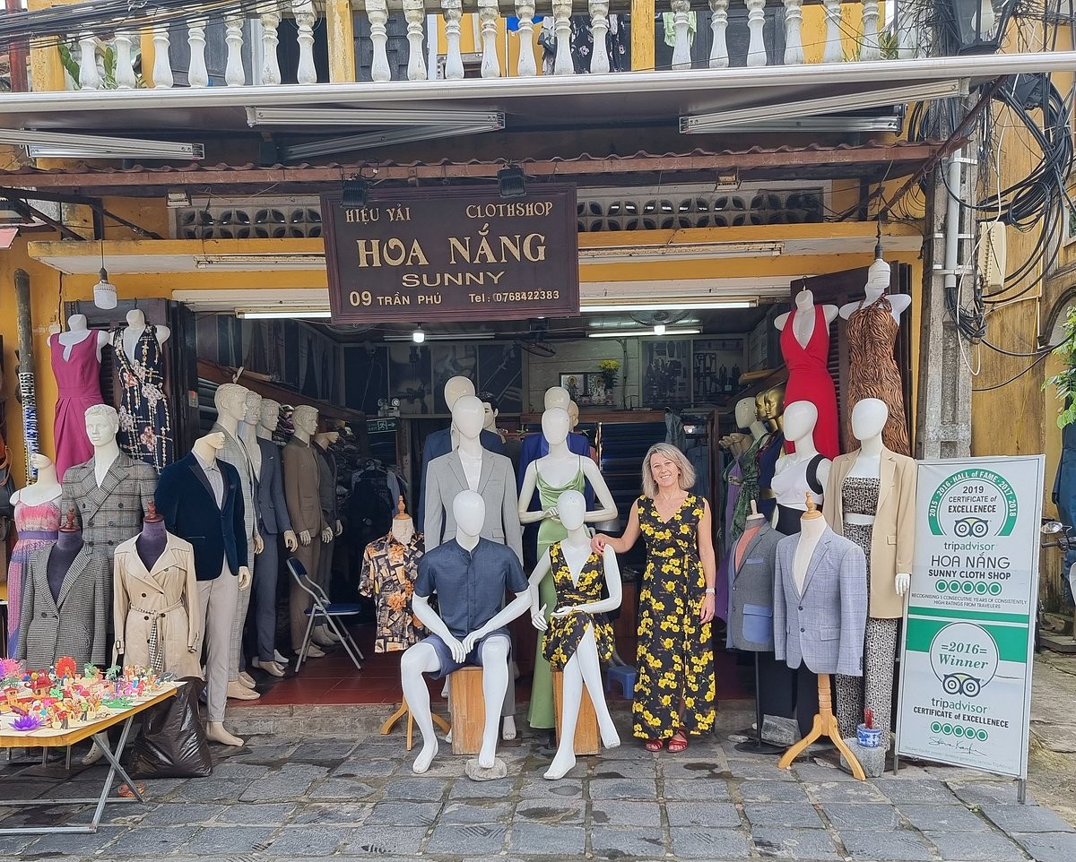 Traveler comparing fabric samples before ordering custom clothing