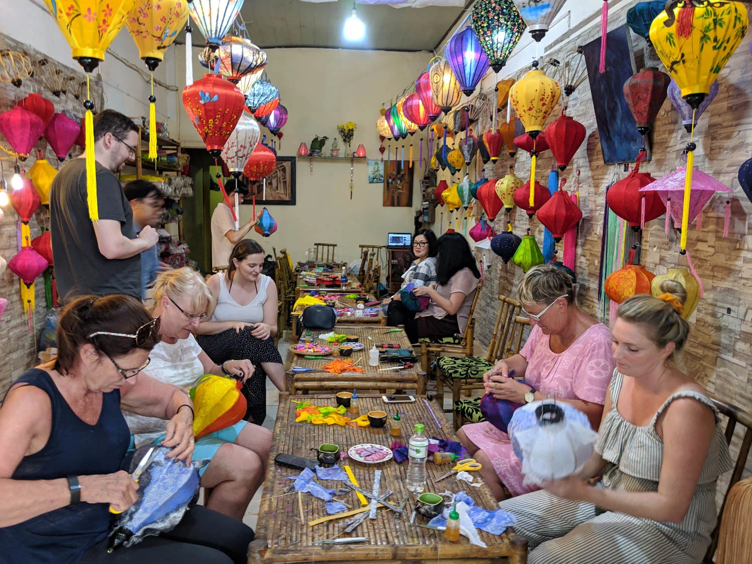 Travelers enjoying a Lantern Making Class with local artisans in Hoi An