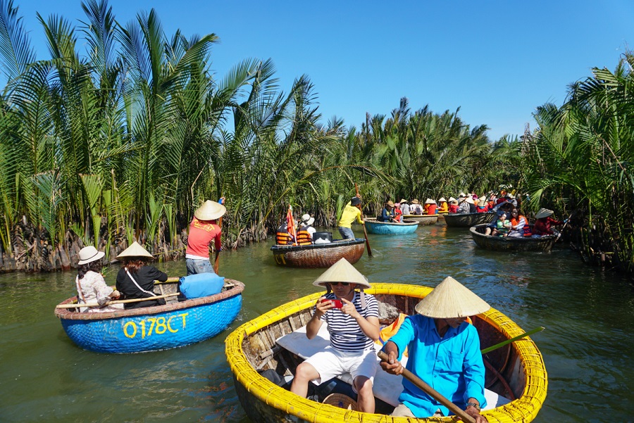 Travelers enjoying a bamboo basket boat ride in Hoi An coconut forest