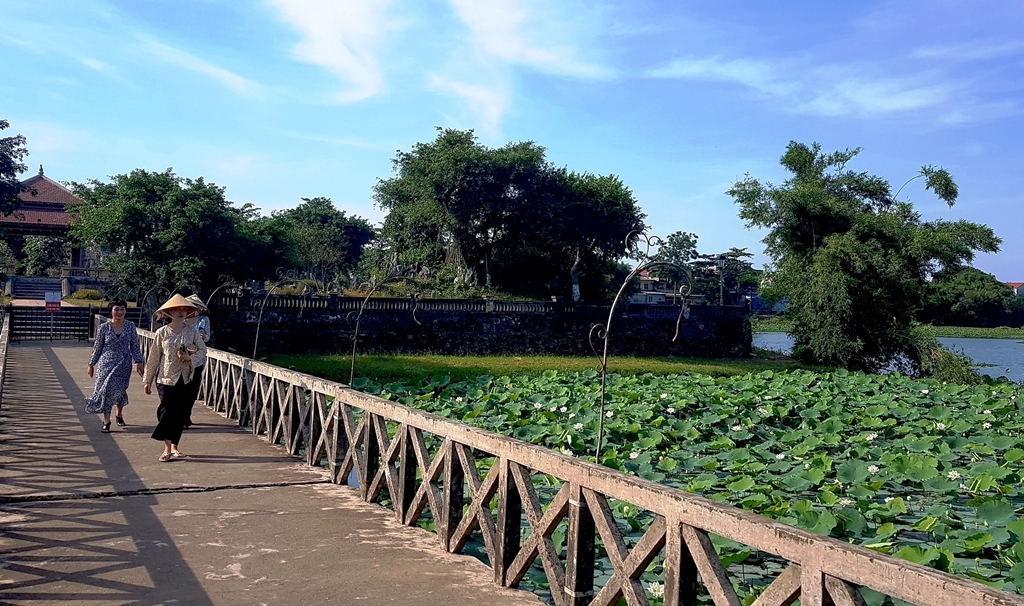 Travelers enjoying scenic views at Tinh Tam Lake in Hue
