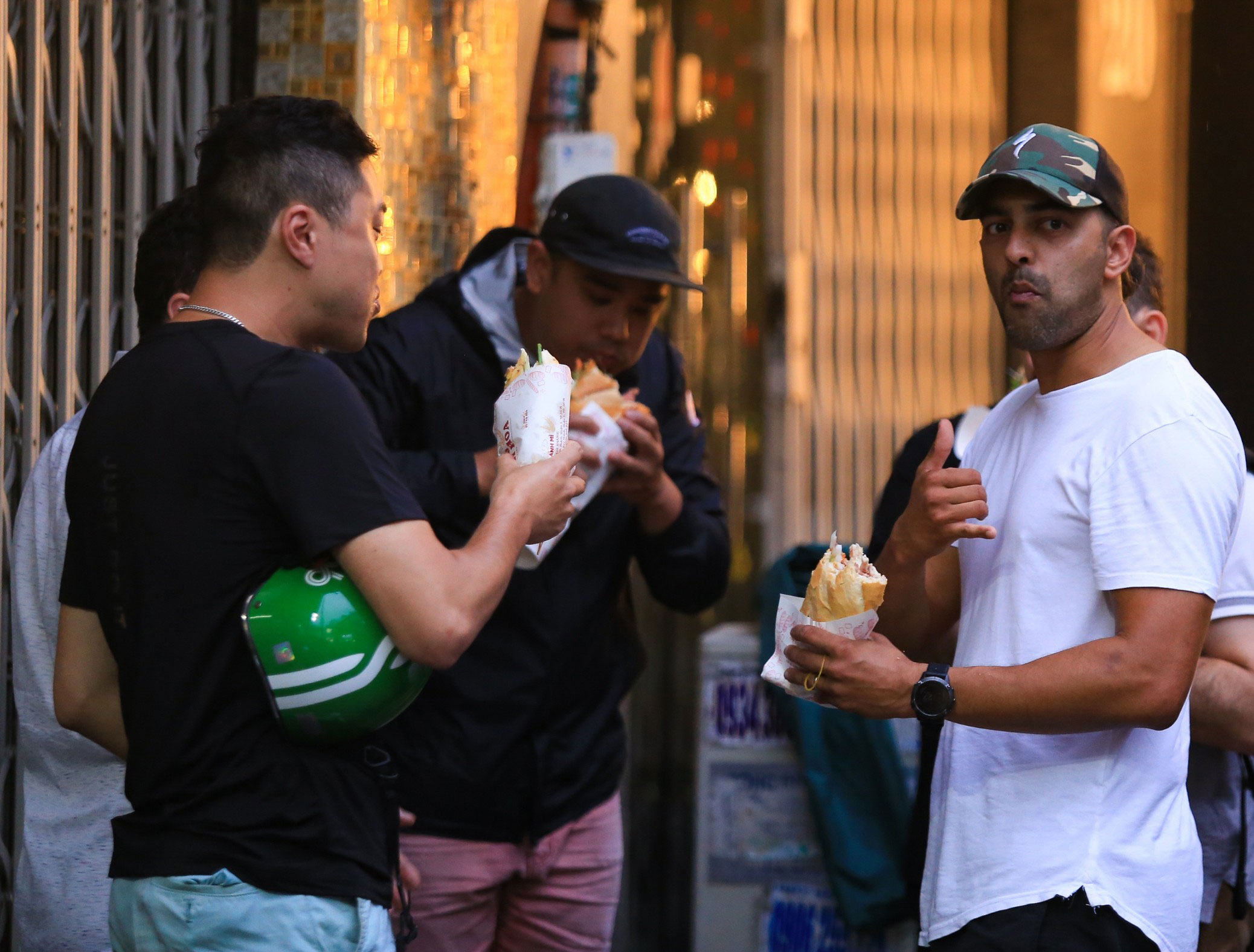 Travelers experiencing Vietnamese street food culture through banh mi