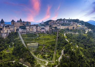 A stunning view of Ba Na Hills during a Full Day Ba Na Hills tour, featuring the iconic Golden Bridge surrounded by lush mountains and misty clouds