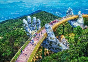 Golden Bridge at Ba Na Hills captured during a Full Day Ba Na Hills tour, showcasing its iconic giant hands holding the shimmering walkway above the clouds.