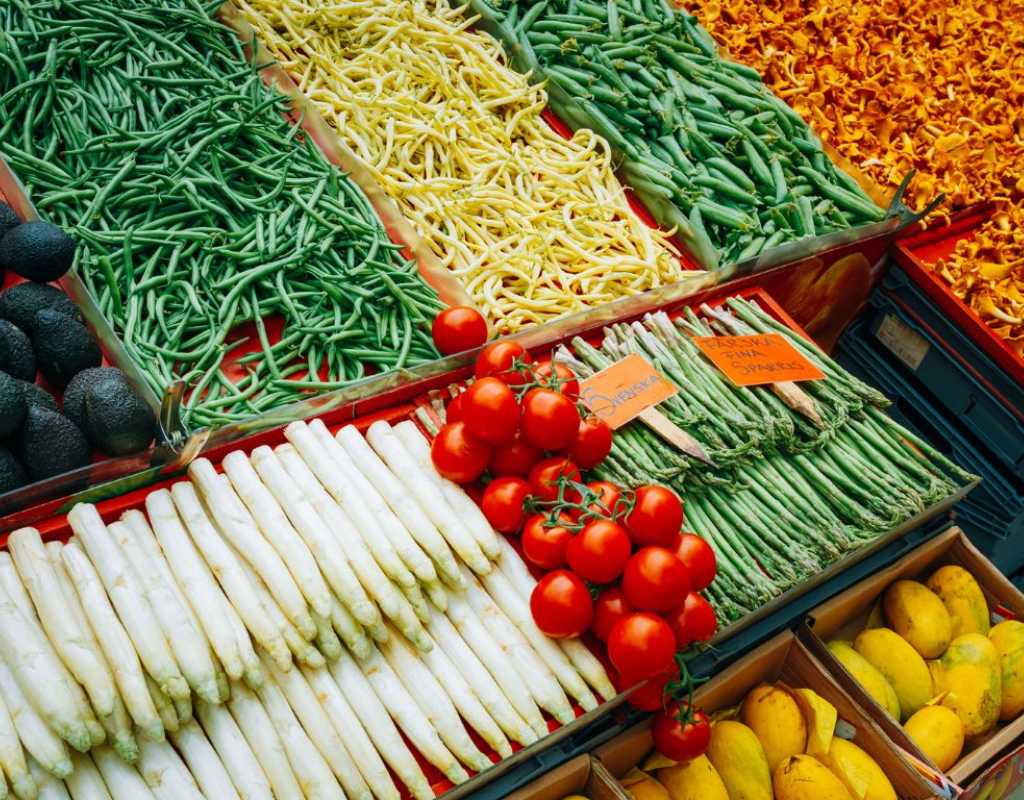 colorful display of fresh, vibrant vegetables and ingredients at a local open-air market.