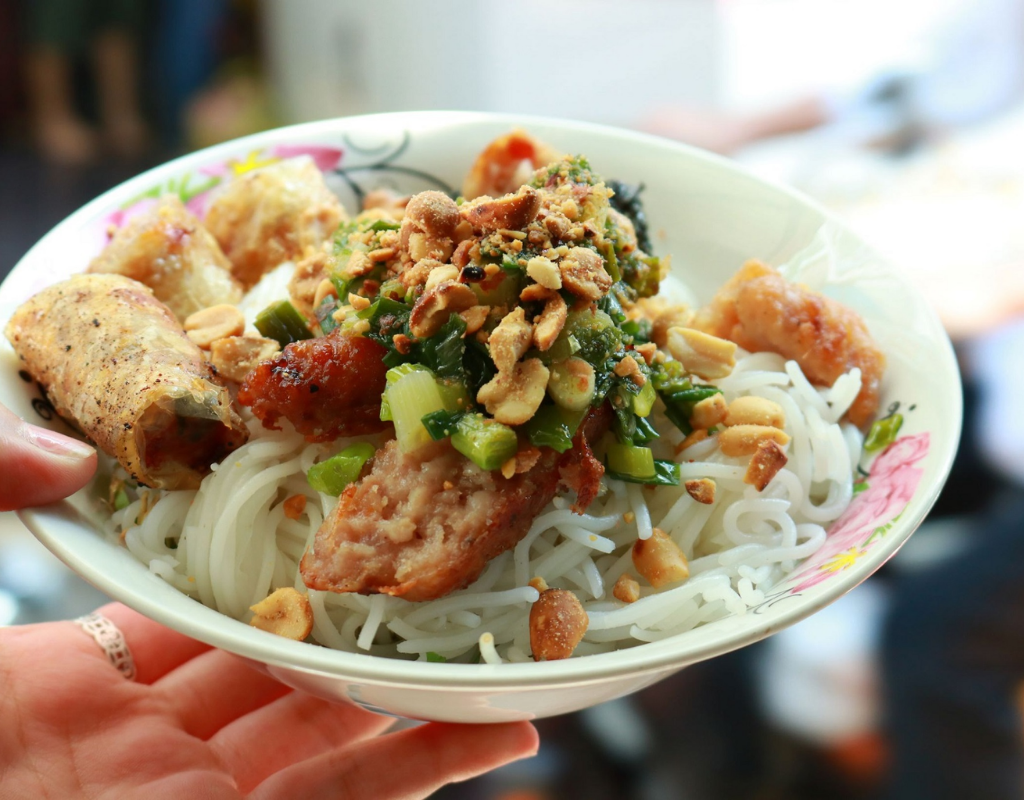 Grilled pork, rice vermicelli, herbs, vegetables, and peanuts create a fresh and satisfying local meal.