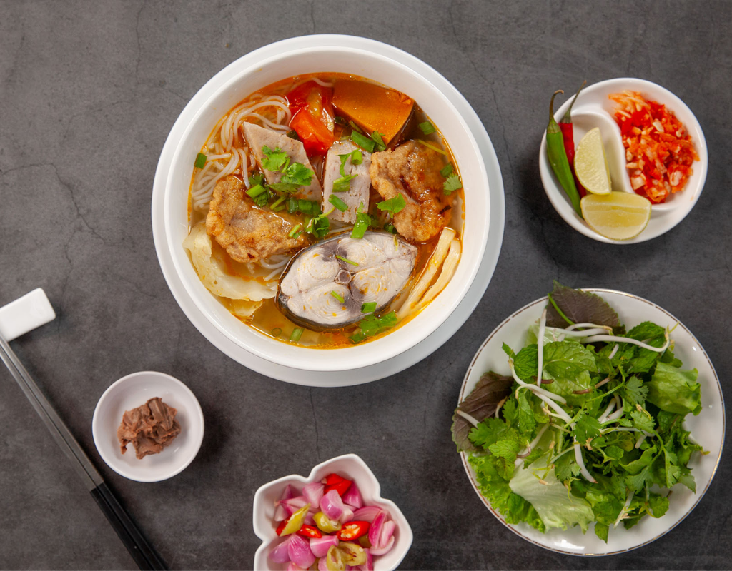 A warm bowl of Bun Cha Ca brings together fish cakes, rice noodles, vegetables, and an aromatic broth.