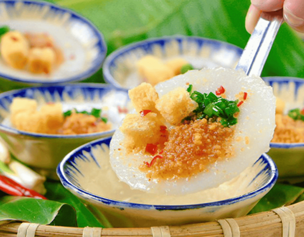 Delicate steamed rice cakes are topped with savory shrimp, scallions, and crispy ingredients.